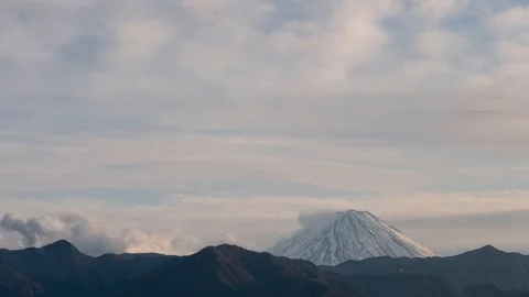 A timelapse of clouds building up over the peak of Mt. Fuji in the evening Stock Footage 122274563