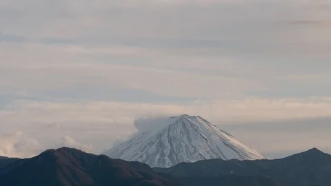 A timelapse of clouds building up over the peak of Mt. Fuji in the evening Stock Footage 122276719