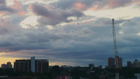 Timelapse of clouds with buildings in the horizon looking west in Toronto Stock Footage 104535739