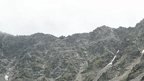 Timelapse of clouds clearing over rocky mountain slope Stock Footage 345088698