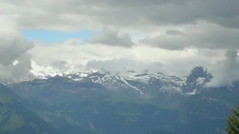 Timelapse Clouds dancing around snowy mountain peaks. A scenic landscape Video stock 152524936
