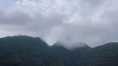 Timelapse - Clouds dancing on a mountain during rainy season 4K60 Stock Footage 270895396