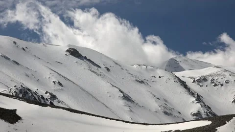 Timelapse clouds drifting above snow covered - Sky Texture and Cloud Transition Stock Footage 339561133