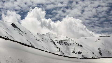Timelapse clouds drifting above snow covered - Cloud Shadows and Cloud Contrast Stock Footage 339561163