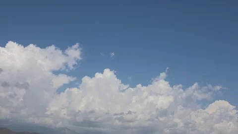 Timelapse of Clouds Drifting Over Mountain Peaks Under Blue Sky Stock Footage 344731473