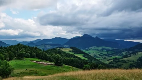 Timelapse ,Clouds Drifting Over a Picturesque Hilly Landscape with a Sheepfold Stock-Footage 314767507