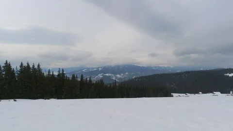 Timelapse of Clouds Drifting Over Snowy Mountain and Pine Forest Stock Footage 320470544