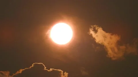 Timelapse of Clouds Drifting Over the Sun in the Sky Stock Footage 148537963