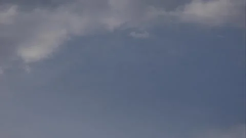 Timelapse clouds drifting slowly across a clear blue sky above an open horizon. Stock Footage 345297884