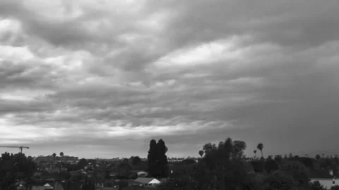 Timelapse clouds dump rain onto Los Angeles in monochrome. 스톡 동영상 230003097