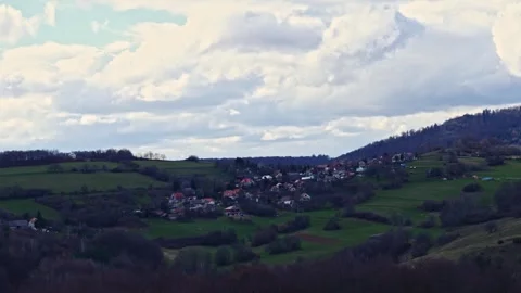 Timelapse of clouds during the day over a small village 스톡 동영상 273154994