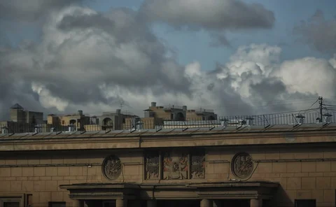 Timelapse clouds float over a building in the city. Video stock 129896533
