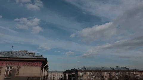 Timelapse clouds float over a building in the city. Video stock 129901301