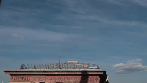 Timelapse clouds float over a building in the city. Video stock 129901433