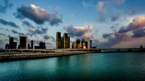 Timelapse of clouds floating above modern buildings at evening 스톡 동영상 64235891