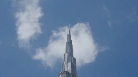Timelapse of clouds floating across sky and reflections in spire of Burj Khalifa Stock-Footage 331728553