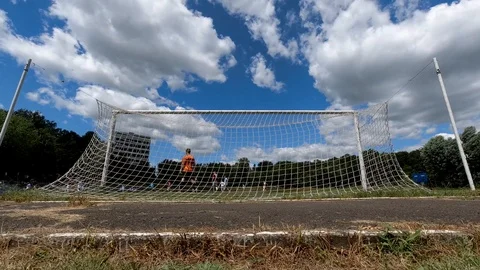 Timelapse clouds floating in the sky during football match. Camera placed behind Stock Footage 114127813