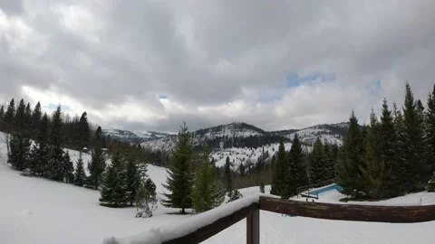 Timelapse clouds floating the sky. Snowed hills and mountains. Winter time. Video stock 145757773