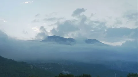 Timelapse clouds fly near the top of the mountains Stock Footage 76294675