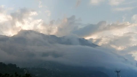 Timelapse clouds fly near the top of the mountains Stock Footage 76295676