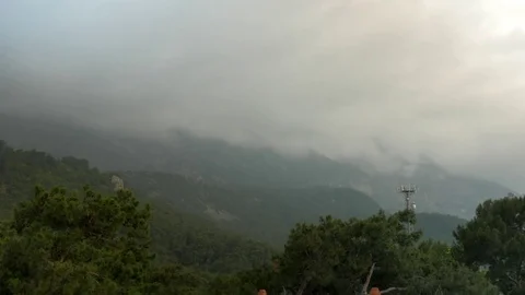 Timelapse clouds fly near the top of the mountains Stock Footage 76477191