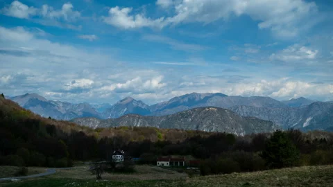 Timelapse clouds fly over house in mountain. Blue mountains. Shadows Stock Footage 196419799