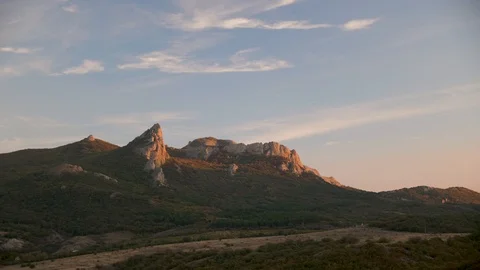 Timelapse with clouds that fly over the mountains during sunset Stock Footage 97060694