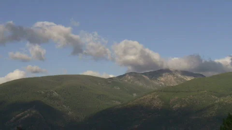 Timelapse - clouds form over mountains Stock Footage 874916
