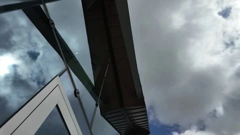 Timelapse of clouds on a glass building Stock Footage 276549083