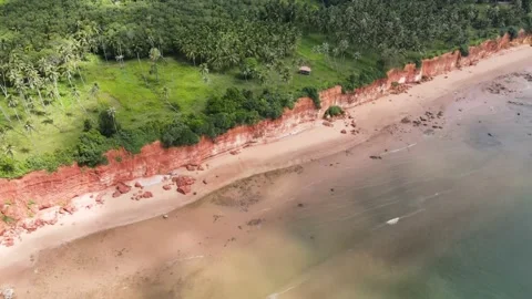Timelapse clouds leaving shadows on the red  cliff beach. Video stock 204070840