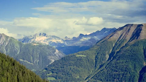 Timelapse of Clouds Morphing and Moving Over Swiss Alps Video stock 254060968