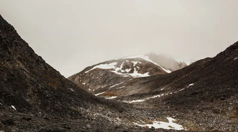 Timelapse Clouds move through rocky ravine with low clouds Stock Footage 62130296
