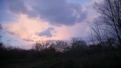 Timelapse of clouds moving above a forest. Video stock 86813469