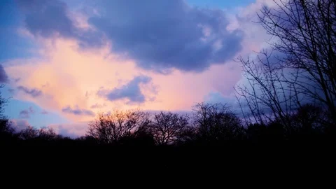 Timelapse of clouds moving above a forest. Video stock 86826192