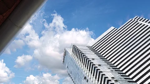 Timelapse of clouds moving above a modern skyscraper Stock Footage 337298122