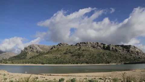 Timelapse of clouds moving above the mountains during a summer day in mallor Stock Footage 166393600