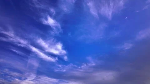 Timelapse of clouds moving across a blue sky, creating a stunning visual display Stock Footage 289140777