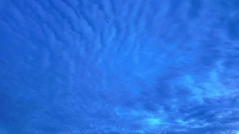Timelapse of clouds moving across a blue sky creating a mesmerizing pattern Stock Footage 290486208