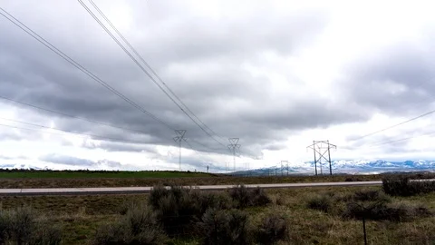 Timelapse of clouds moving across the desert sky with powerlines Stock Footage 113507445