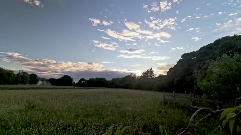 Timelapse of Clouds Moving Across an English Countryside Landscape at Golden Stock Footage 340856984