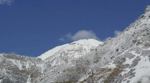 Timelapse of clouds moving across snow covered mountains Video stock 52878816