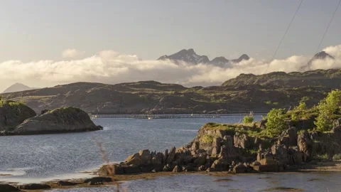 Timelapse clouds moving across snowy peak and ocean in Mortsund Lofoten Stock Footage 277352669