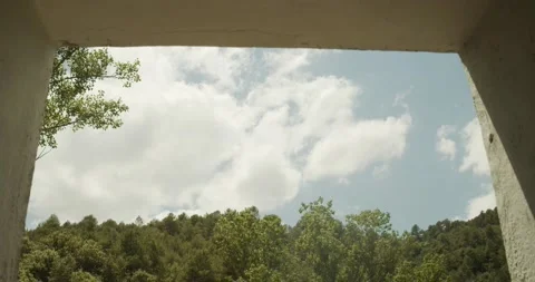 Timelapse of clouds moving in a blue sky seen from the window of a house Stock Footage 133895415
