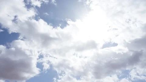 Timelapse of clouds moving in a blue sky with big sun Stock Footage 140403692