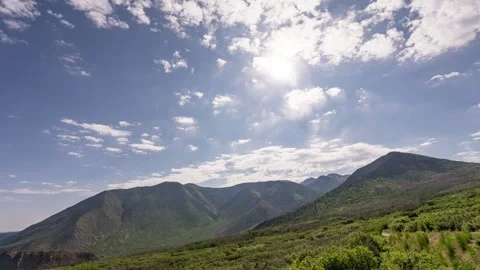 Timelapse of clouds moving fast over a mountain landscape in 4k Video stock 338096340