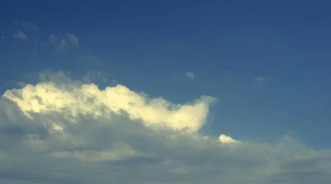 Timelapse of clouds moving from left to right. Warm tone in late evening light. Stock Footage 68343841