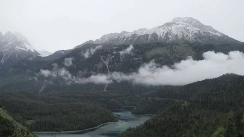 Timelapse of clouds moving in the mountains above a lake Vídeos de archivo 208844377