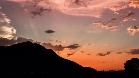 Timelapse of clouds moving in orange sky during sunset Stock Footage 77815251