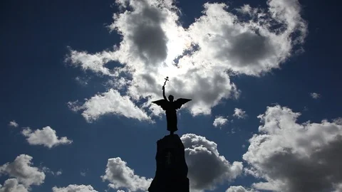 Timelapse clouds moving over Angel statue on sunny day Stock Footage 89662609