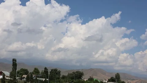 Timelapse of Clouds Moving Over City with Mountains in the Background Stock Footage 344733257